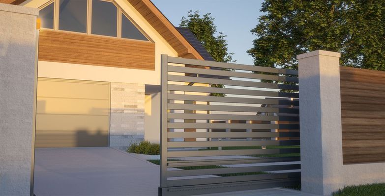 A modern house with a sliding gate in front of it.