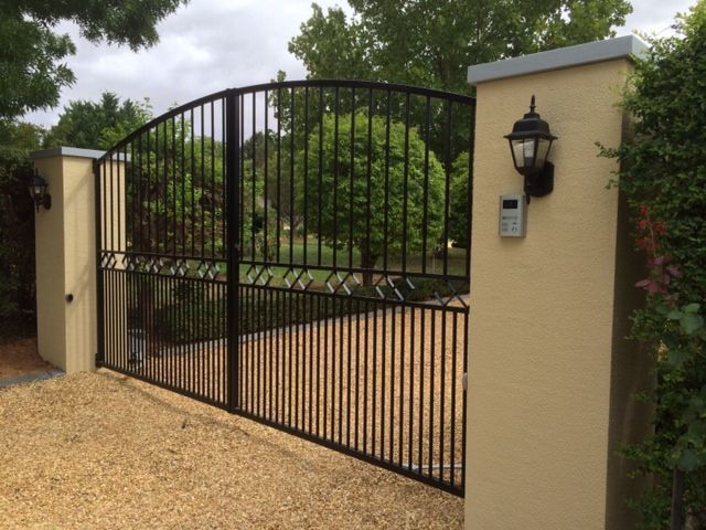 A black gate with a light on the side of it