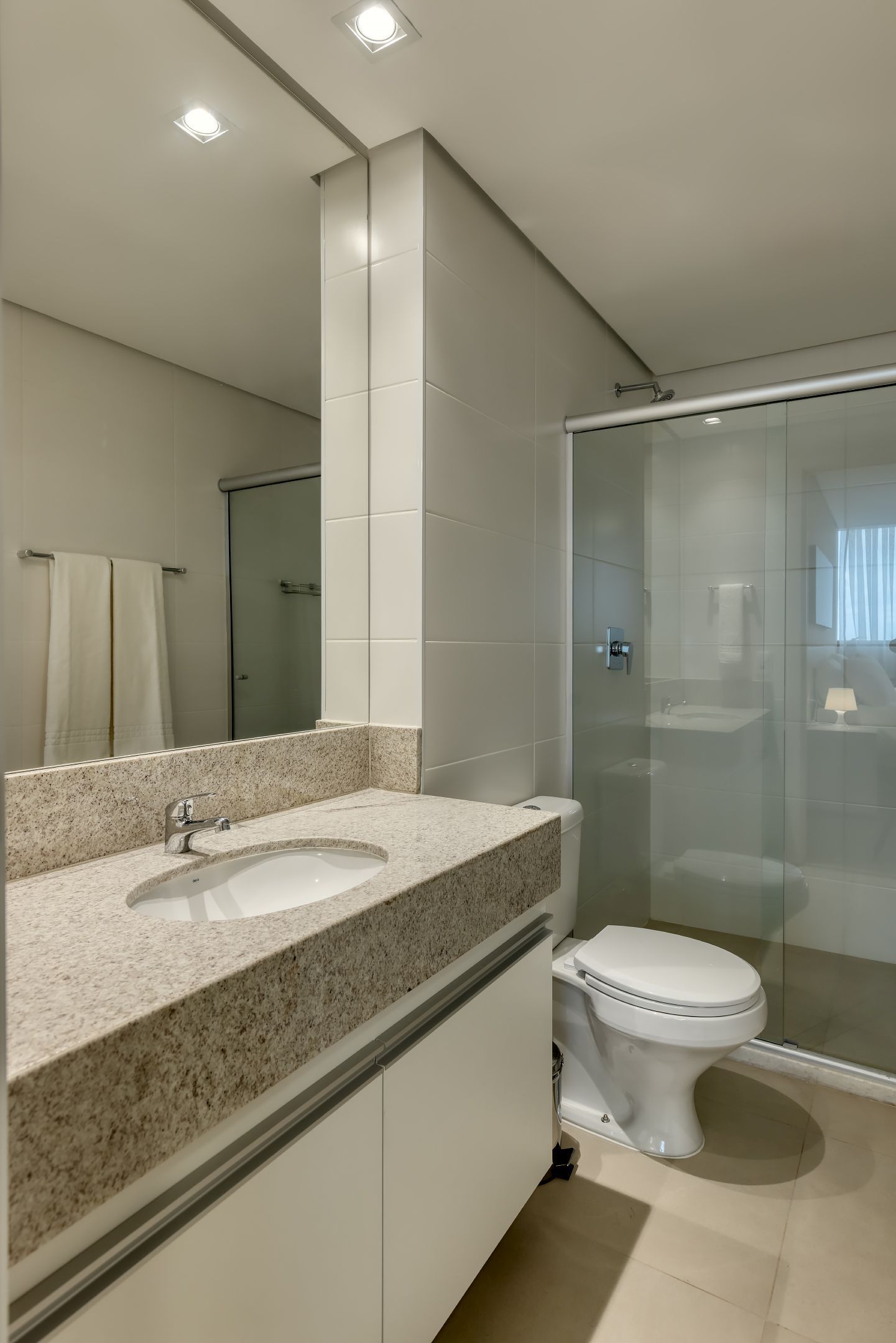 Um banheiro com pia, vaso sanitário e chuveiro.