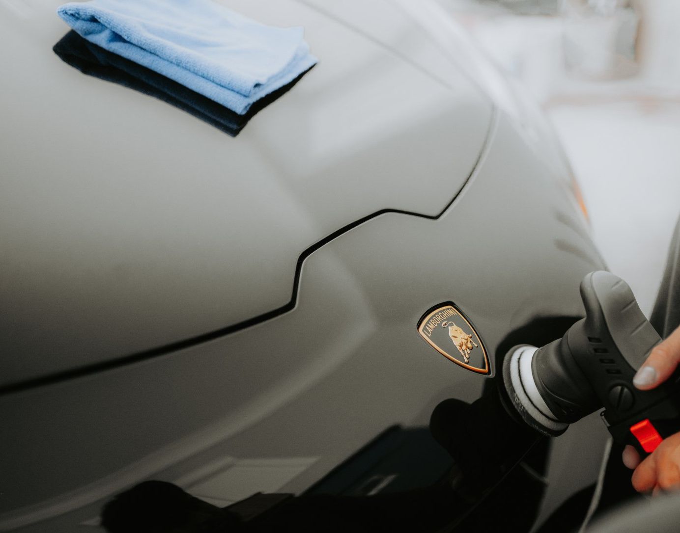 picture of supercar's hood being detailed professionally