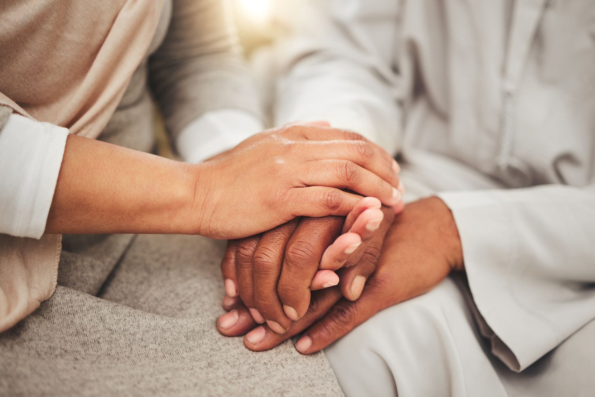 Family Holding An Elderly Persons Hand
