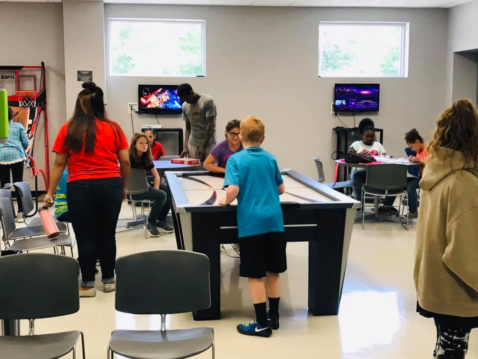 Children playing in game room at clubhouse