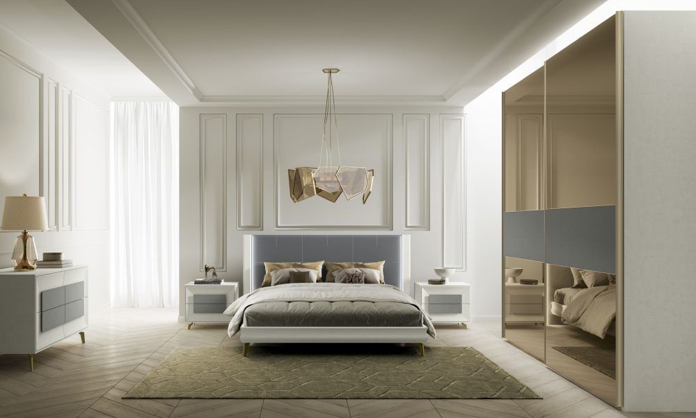 Una camera da letto con un letto, comodino, cassettiera e porte scorrevoli in vetro