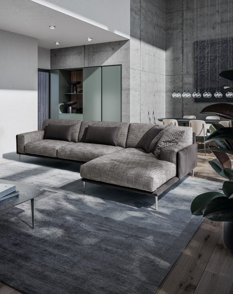 Un soggiorno con un grande divano componibile e un tappeto.