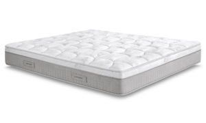 Un materasso bianco è appoggiato su una superficie bianca.