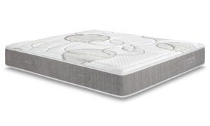 Un materasso bianco è appoggiato su una superficie bianca.