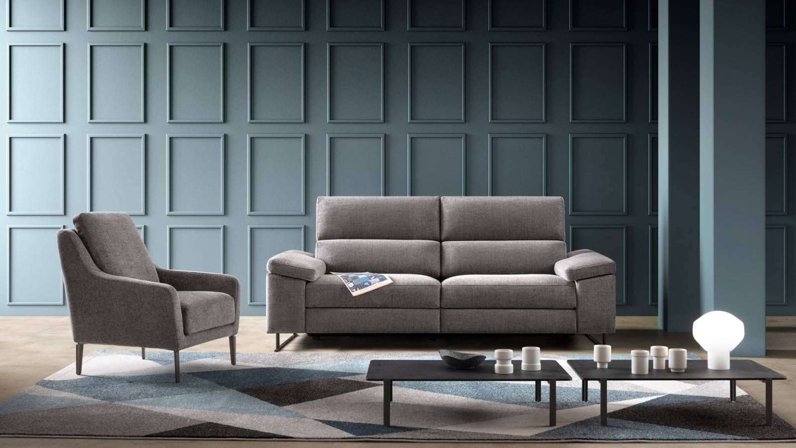 Un soggiorno con un divano, una sedia e due tavolini da caffè