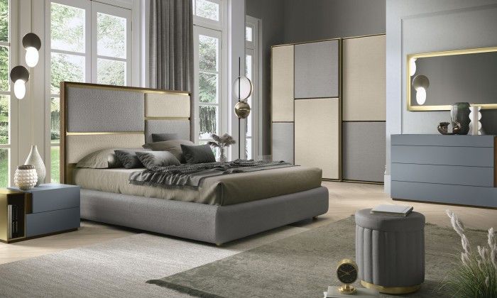 Una camera da letto con letto, cassettiera, comodino e specchio.