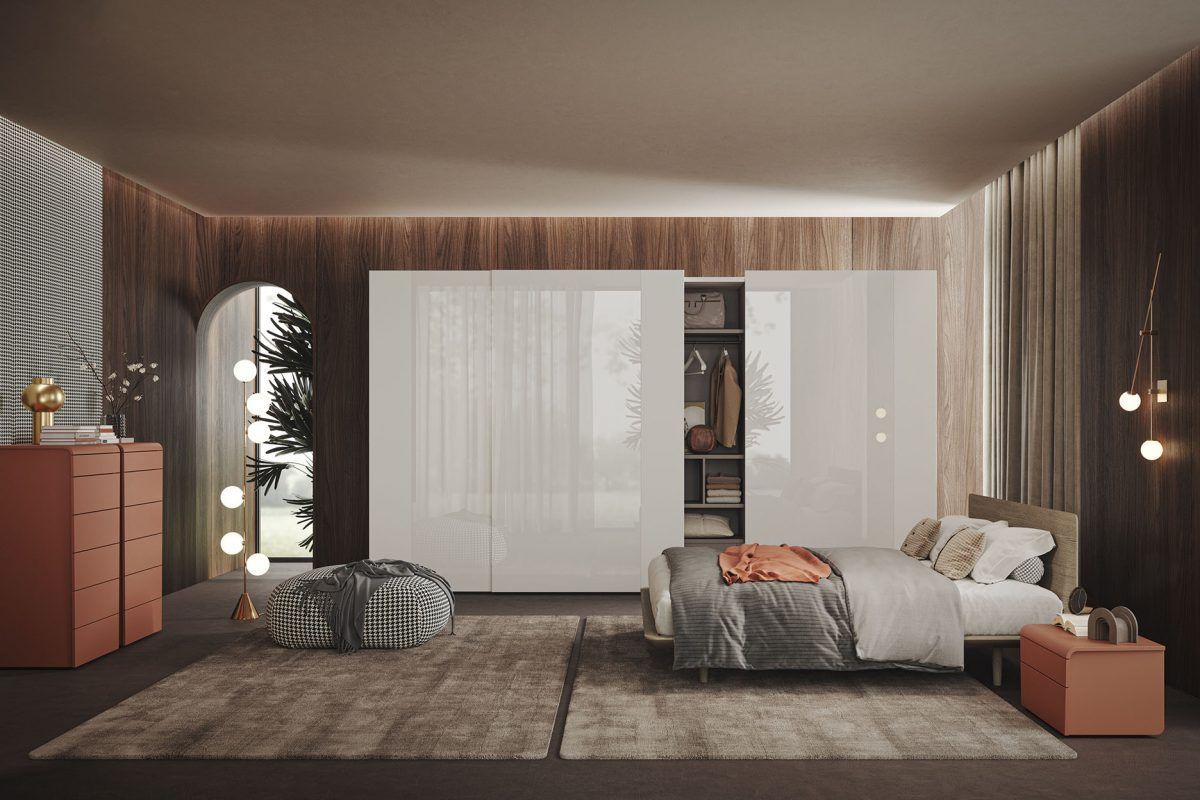 Una camera da letto con un letto, una cassettiera e un comodino