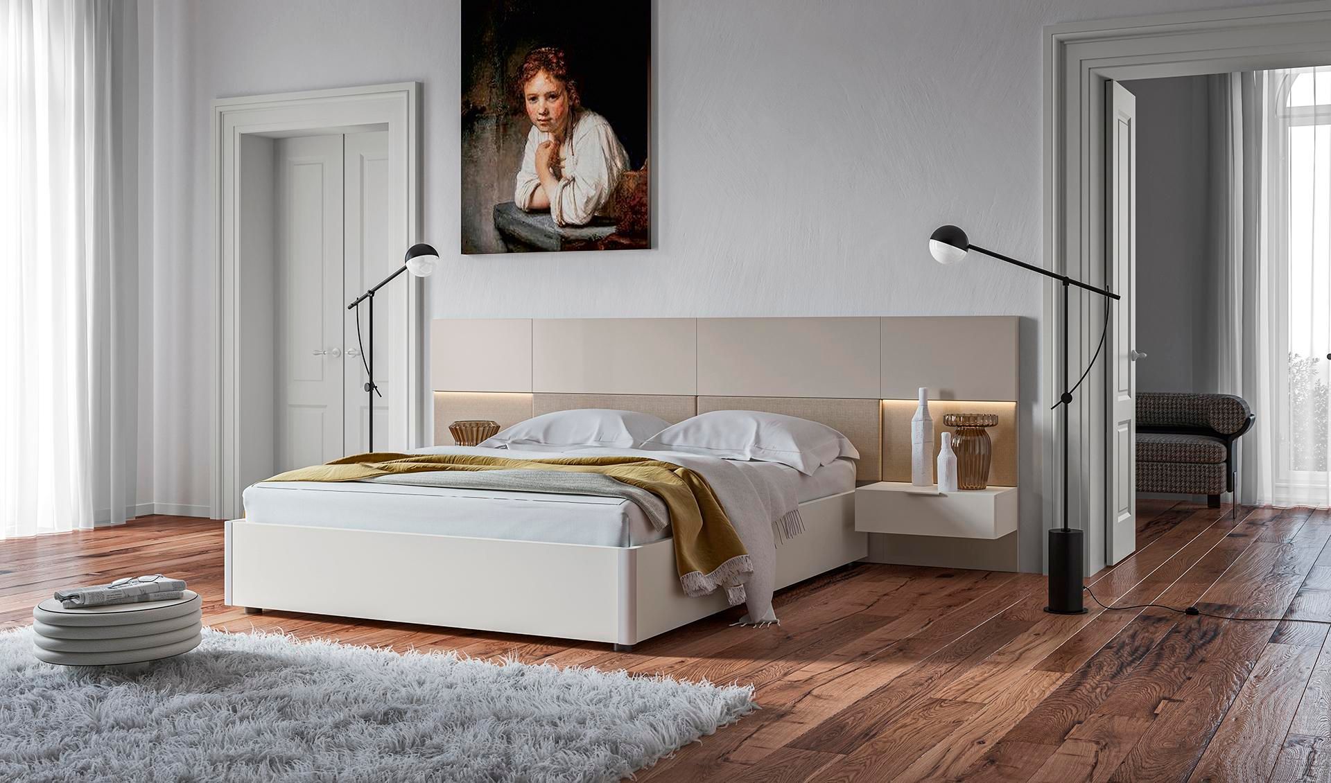 Una camera da letto con un letto e un quadro sul muro