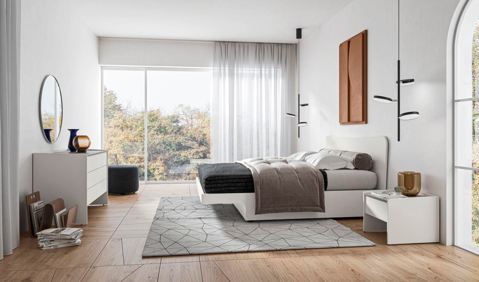 Una camera da letto con un letto, una cassettiera, un comodino e uno specchio