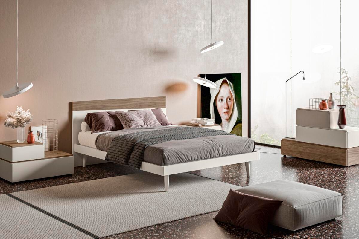 Una camera da letto con un letto e un quadro sul muro