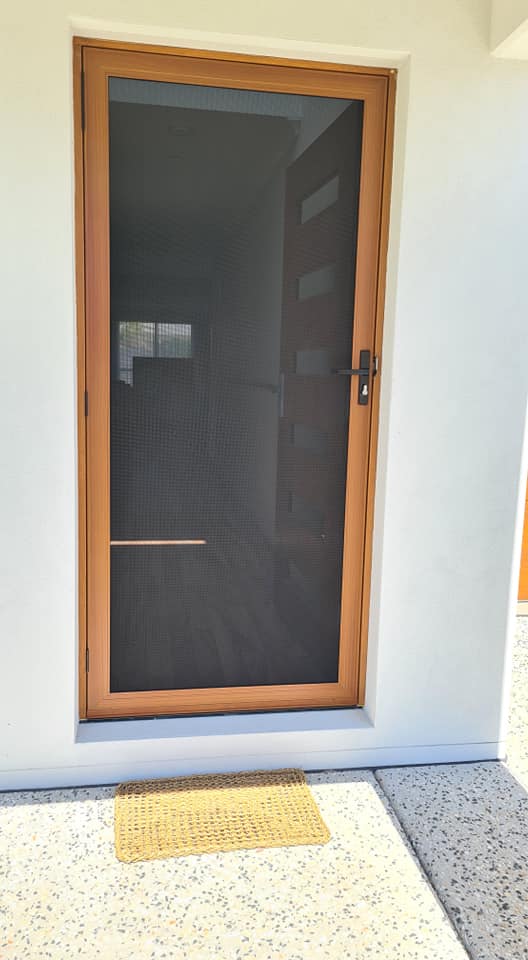 A Door with Orange Frame with Screen — Quality Custom Screens in Caloundra, QLD