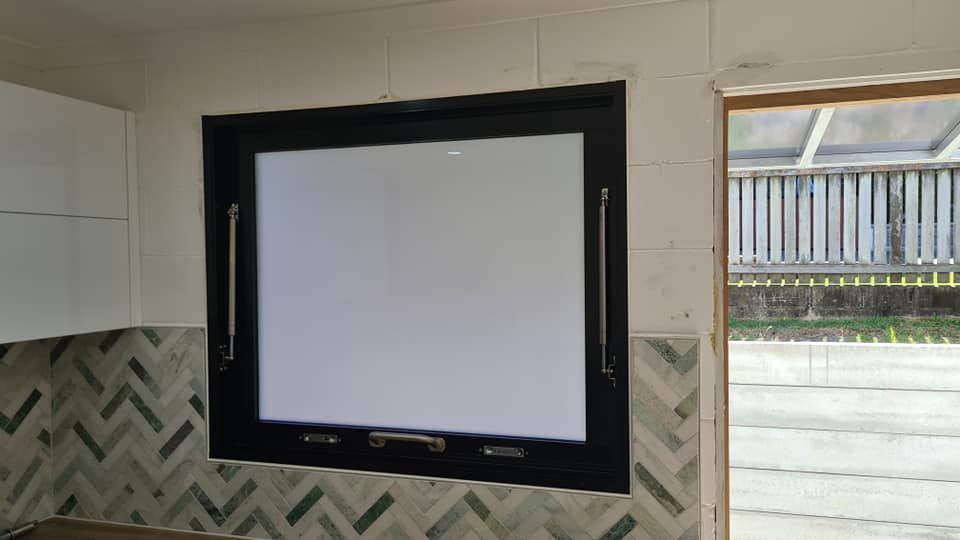 A Shopfront with Black Framed Glass Window — Quality Custom Screens in Caloundra, QLD