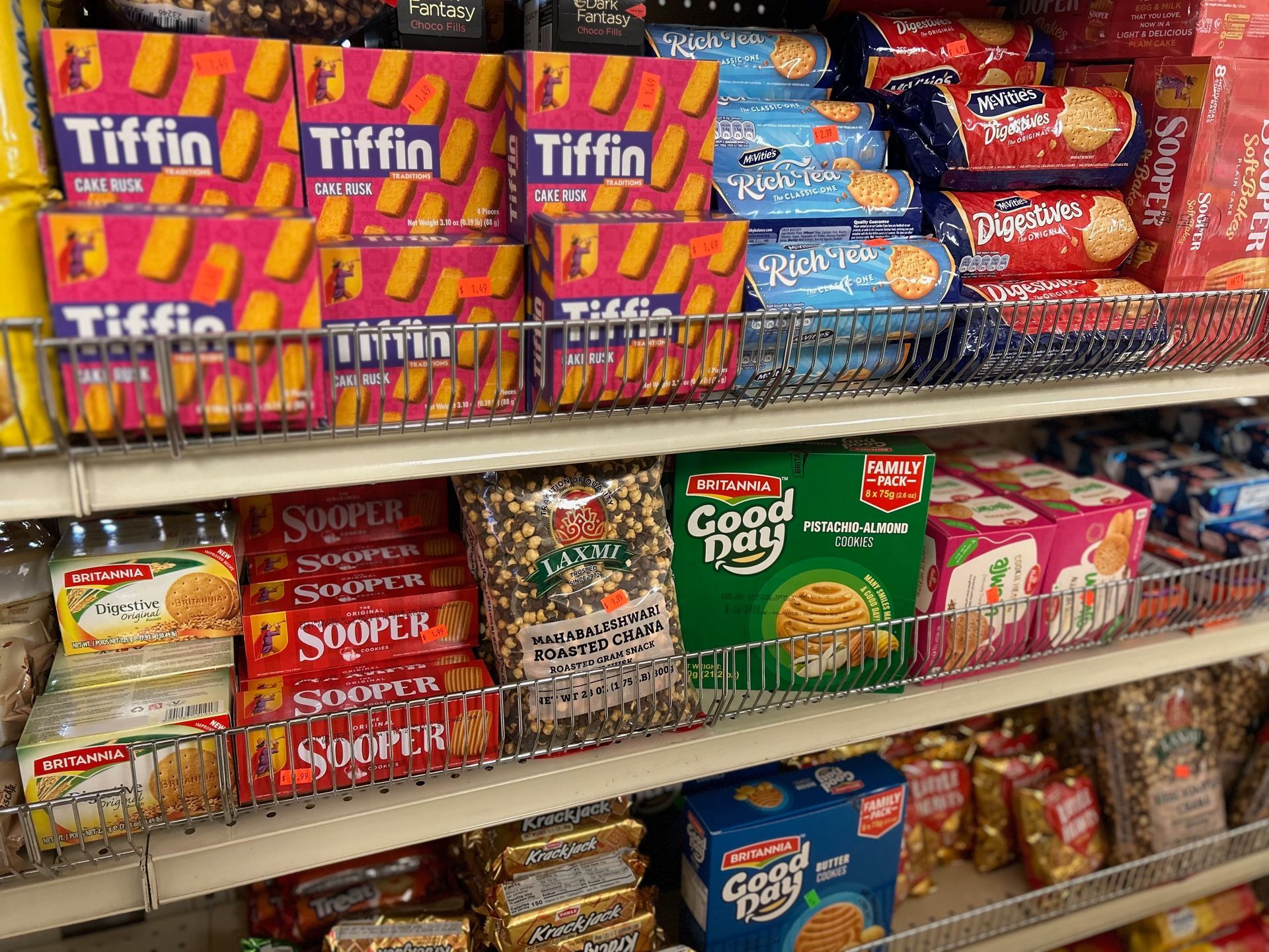 A store shelf filled with a variety of biscuits including tiffin and good day