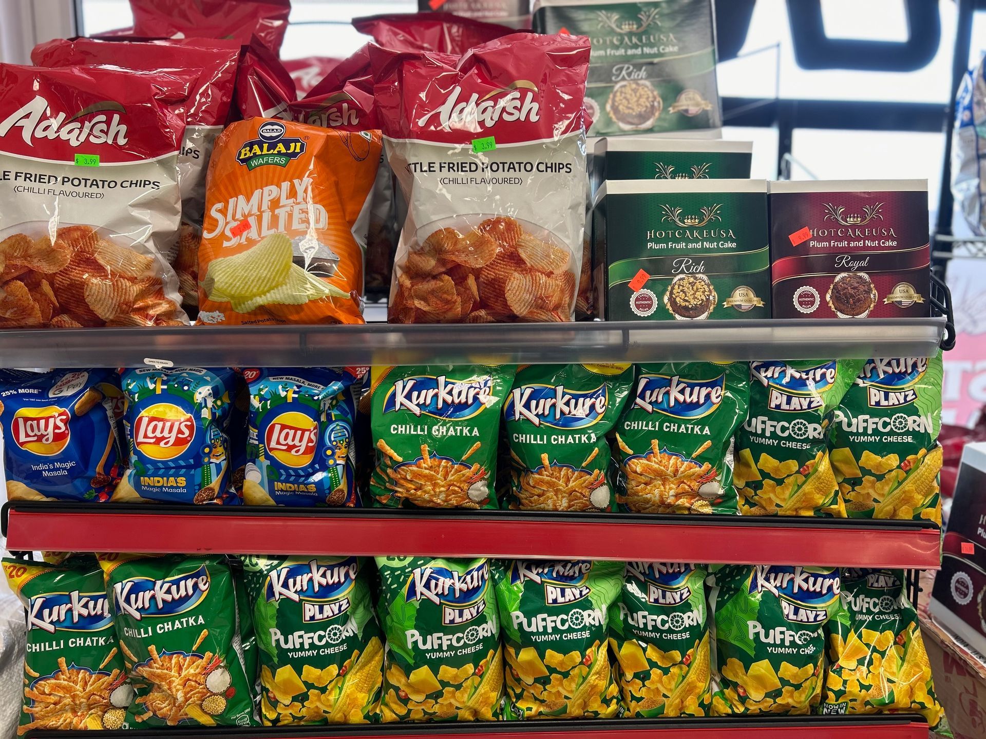 A shelf filled with bags of chips and snacks.