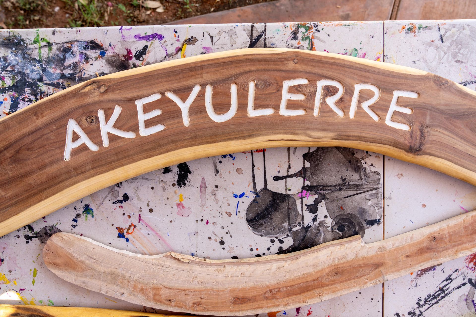 A wooden sign that says ' akeyulerre ' on it