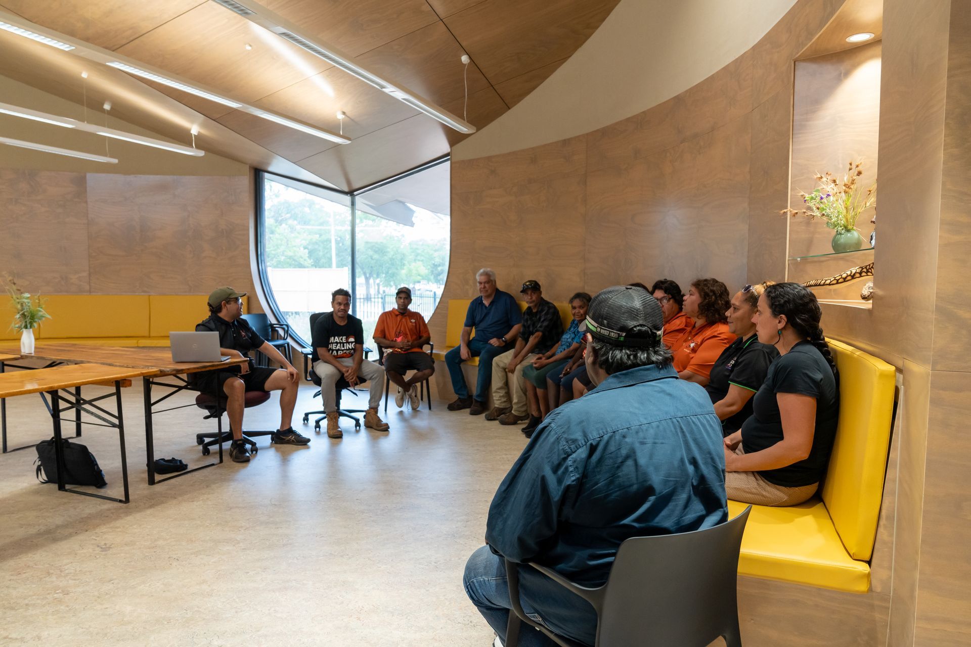A group of people are sitting in a circle in a room.