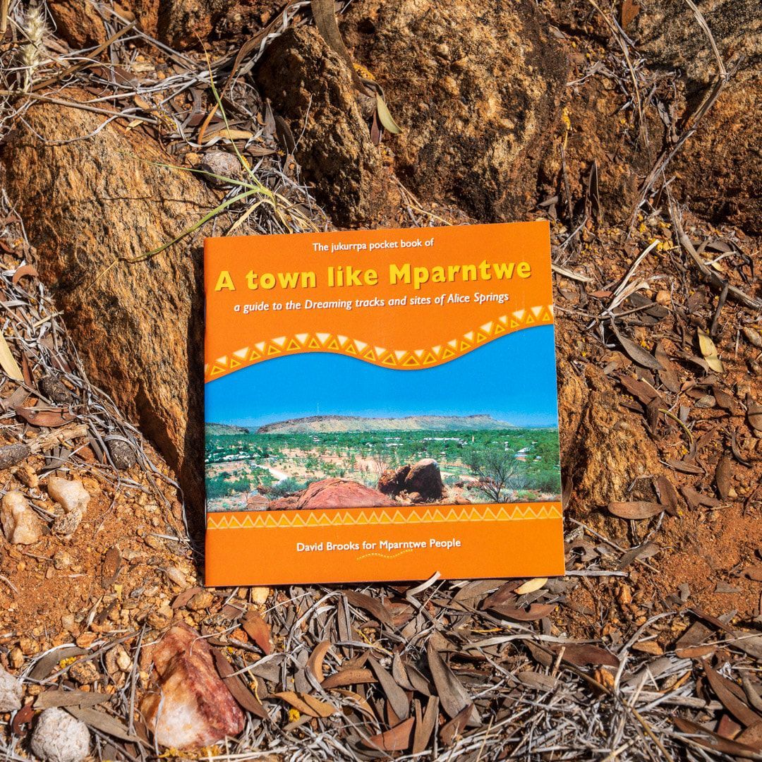 A book titled a town like mparatwe is laying on the ground