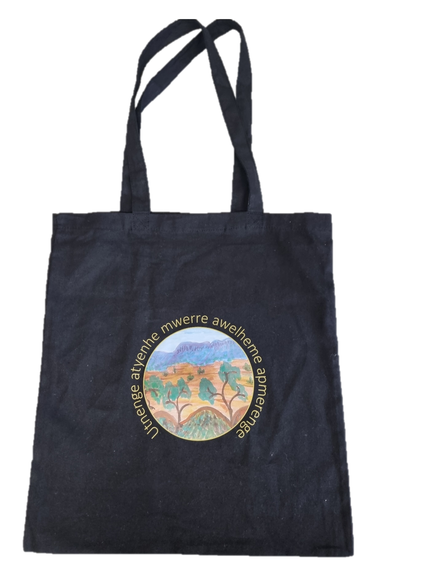 A black tote bag with a picture of a landscape on it