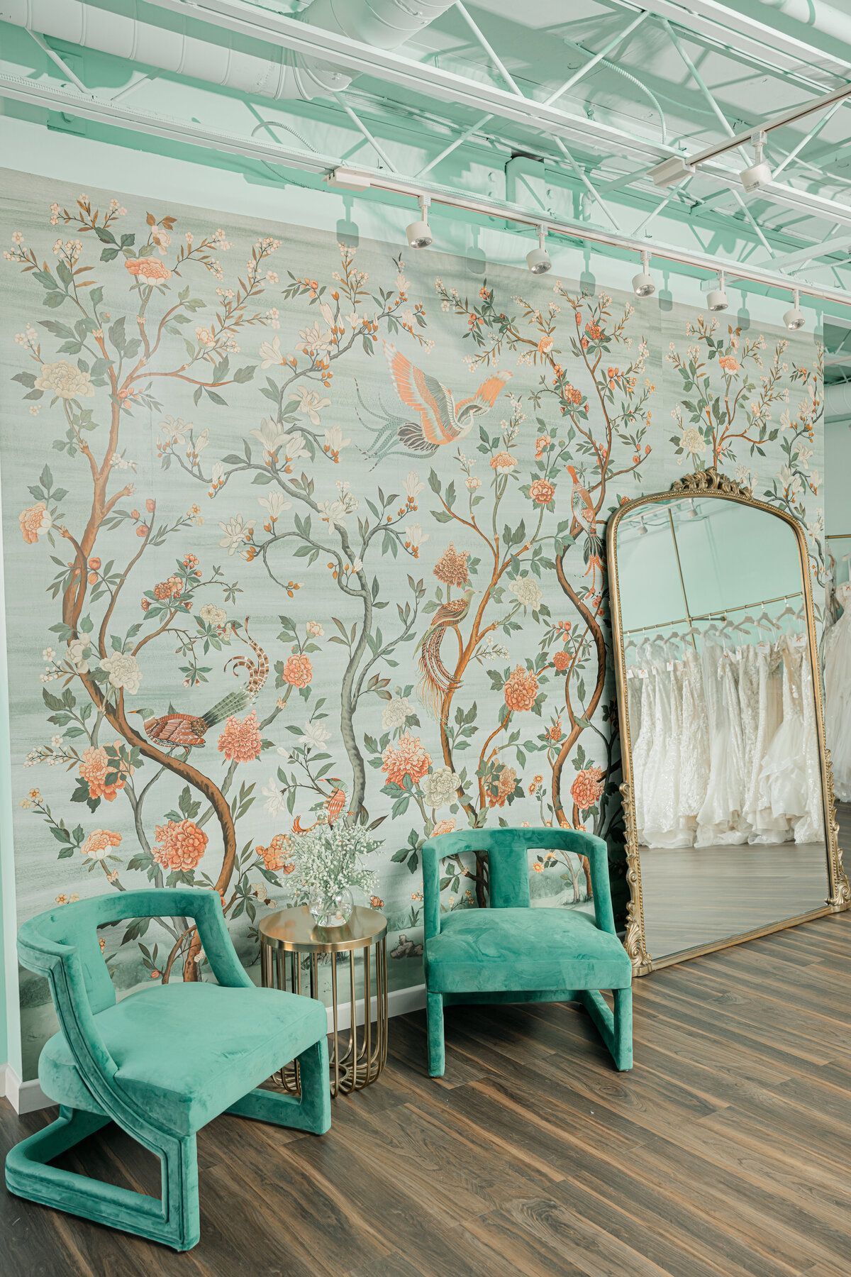 There are two chairs and a mirror in the room.