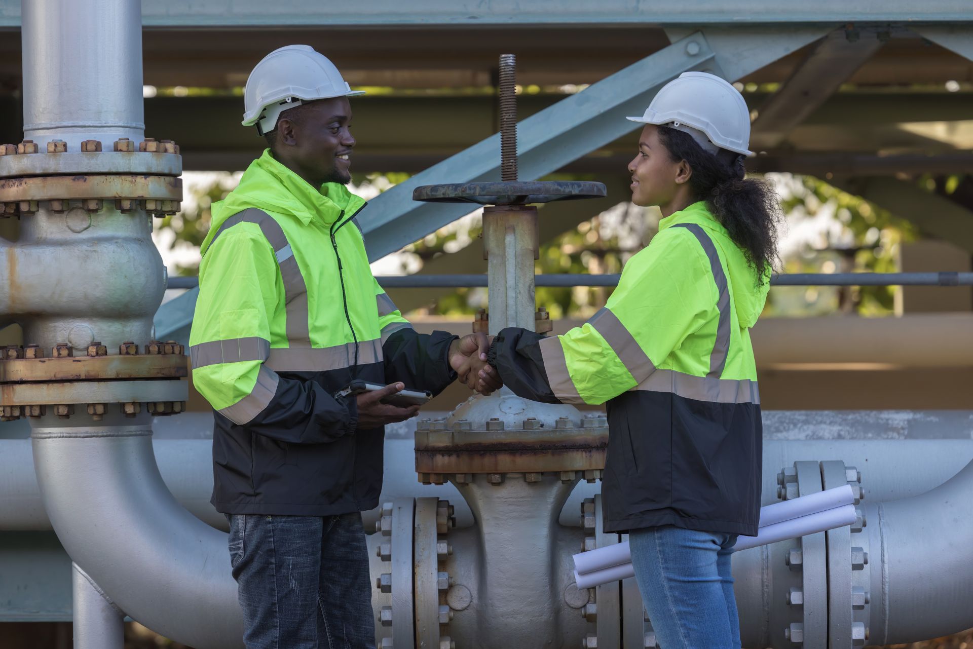 HVAC technician wearing mask and hard hat, working on AC units on a rooftop. HVAC technician wearing mask and hard hat, working on AC units on a rooftop.