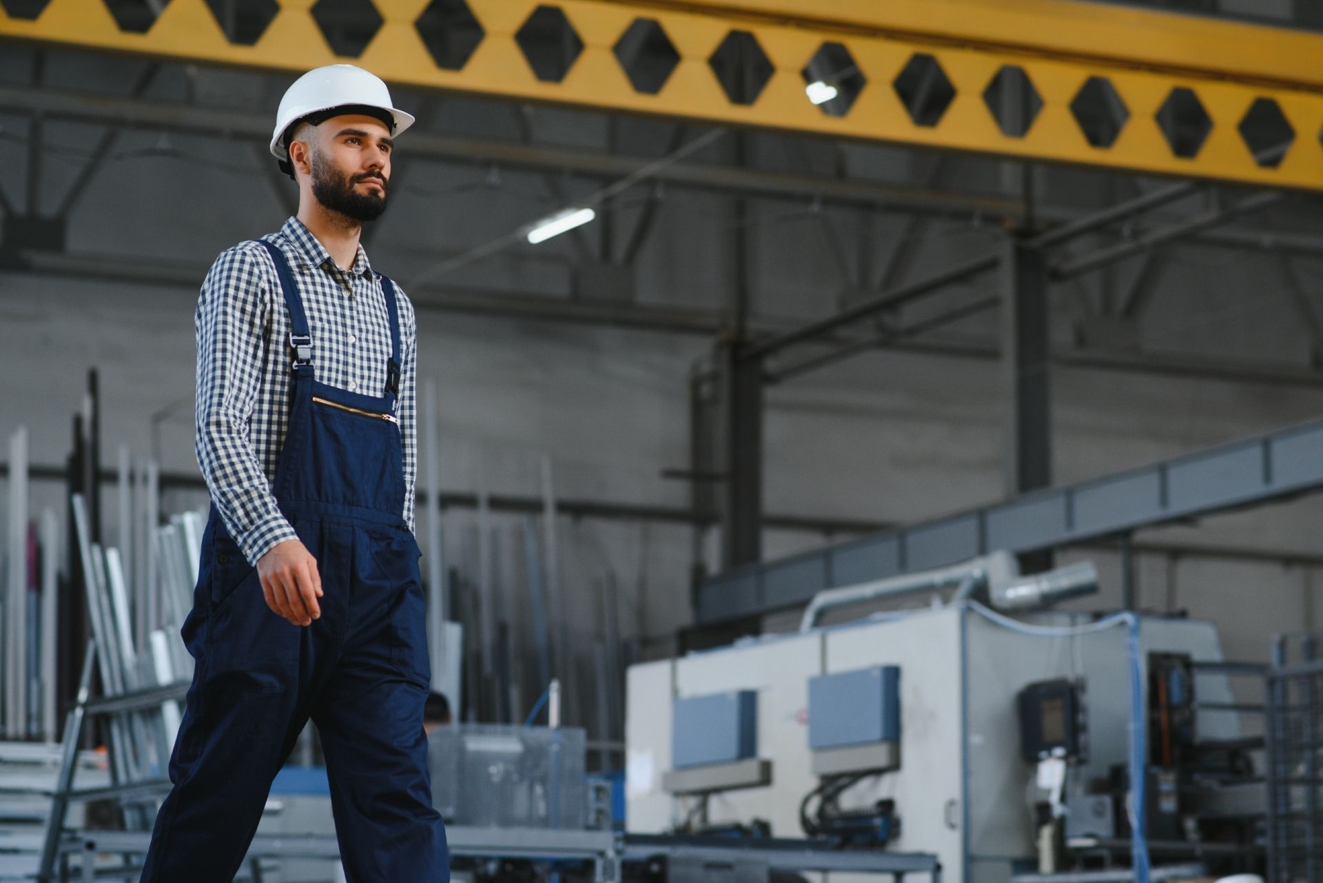 HVAC technician wearing mask and hard hat, working on AC units on a rooftop. HVAC technician wearing mask and hard hat, working on AC units on a rooftop.