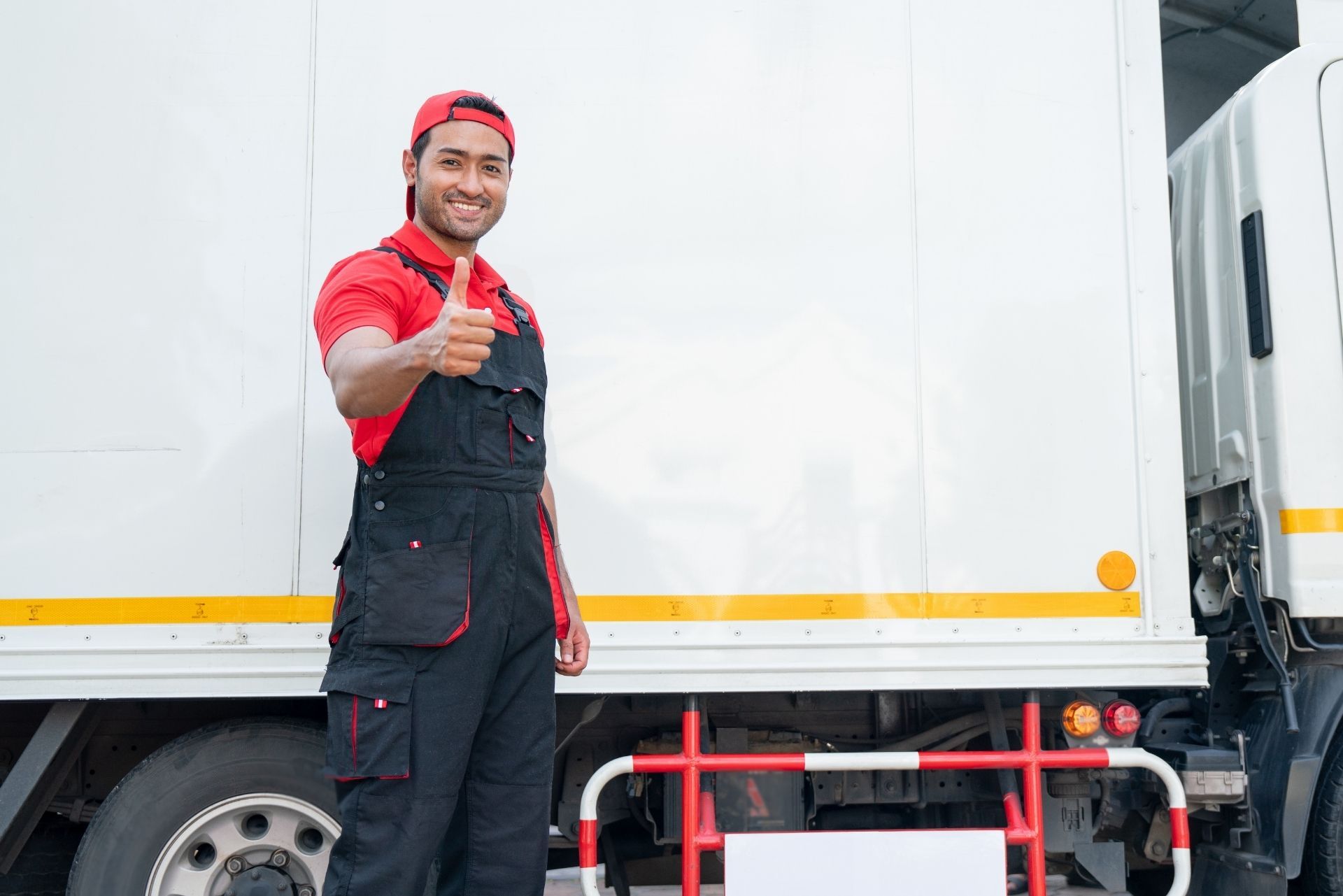 HVAC technician wearing mask and hard hat, working on AC units on a rooftop. HVAC technician wearing mask and hard hat, working on AC units on a rooftop.