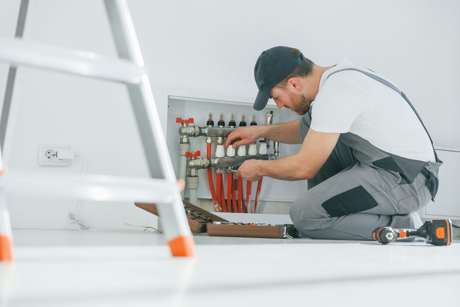 HVAC technician wearing mask and hard hat, working on AC units on a rooftop. HVAC technician wearing mask and hard hat, working on AC units on a rooftop.