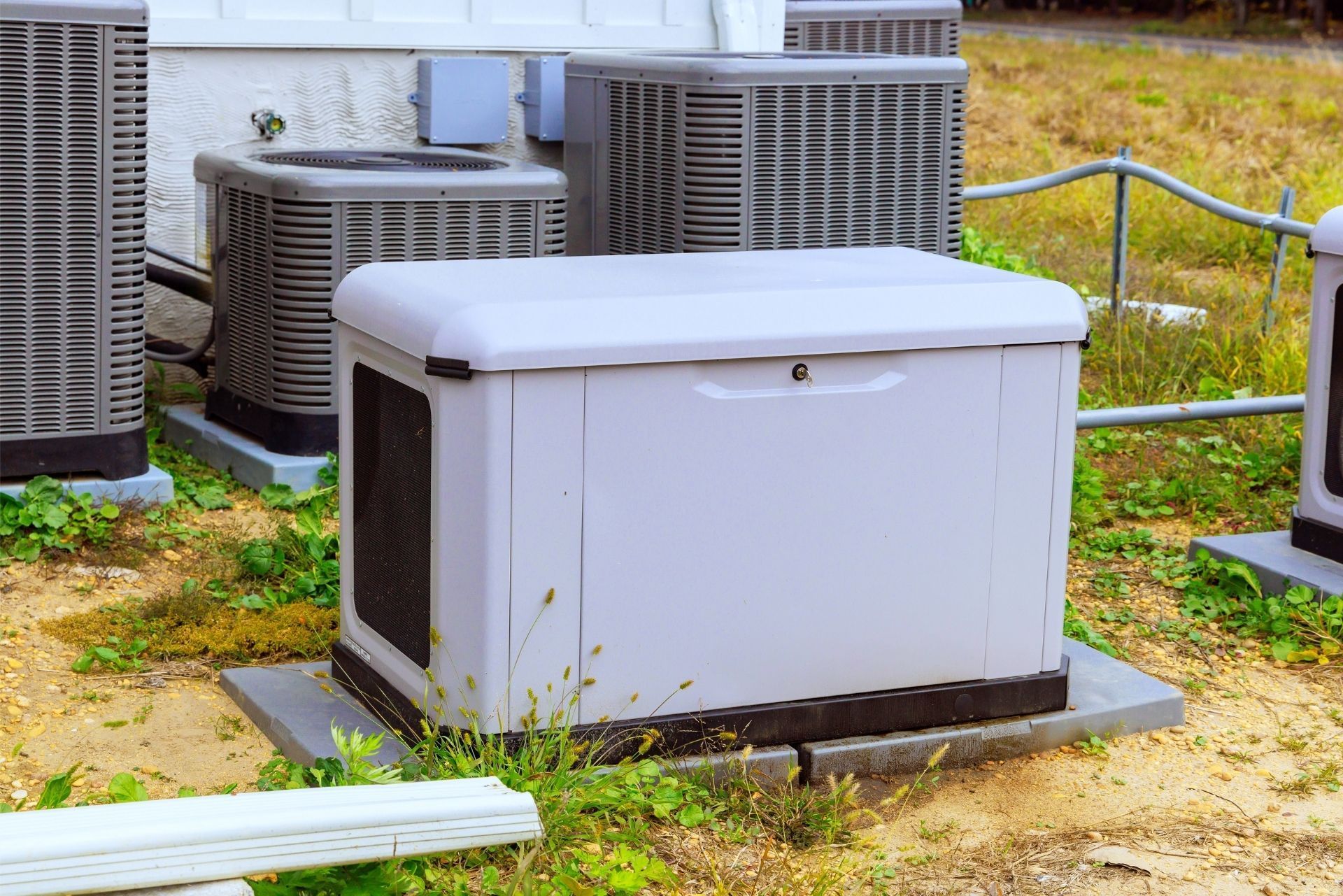 HVAC technician wearing mask and hard hat, working on AC units on a rooftop. HVAC technician wearing mask and hard hat, working on AC units on a rooftop.