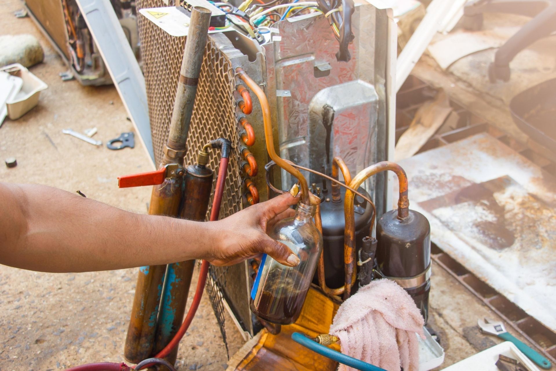 HVAC technician wearing mask and hard hat, working on AC units on a rooftop. HVAC technician wearing mask and hard hat, working on AC units on a rooftop.