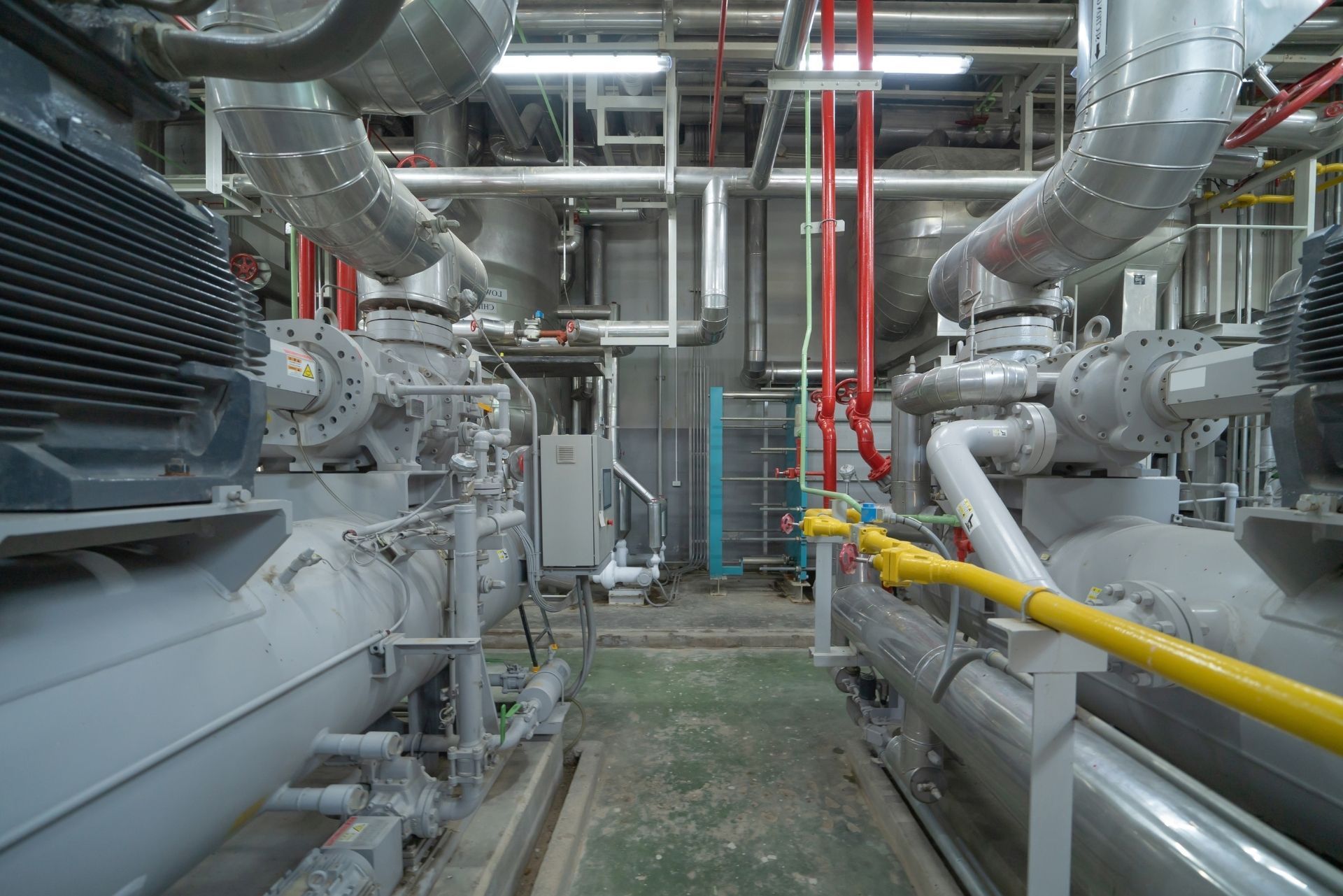 HVAC technician wearing mask and hard hat, working on AC units on a rooftop. HVAC technician wearing mask and hard hat, working on AC units on a rooftop.