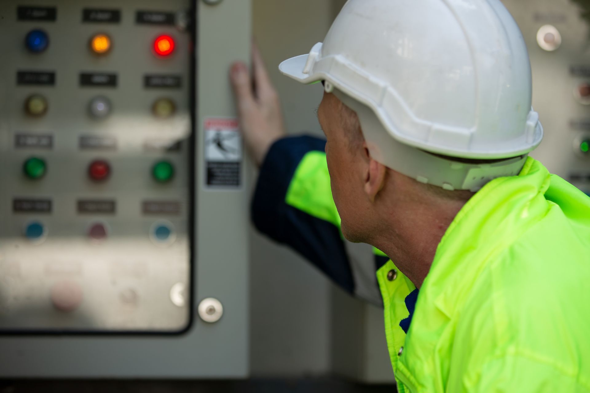 HVAC technician wearing mask and hard hat, working on AC units on a rooftop. HVAC technician wearing mask and hard hat, working on AC units on a rooftop.