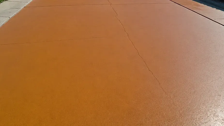 A stunning close-up view of a vibrant stained concrete driveway enhancing residential curb appeal.