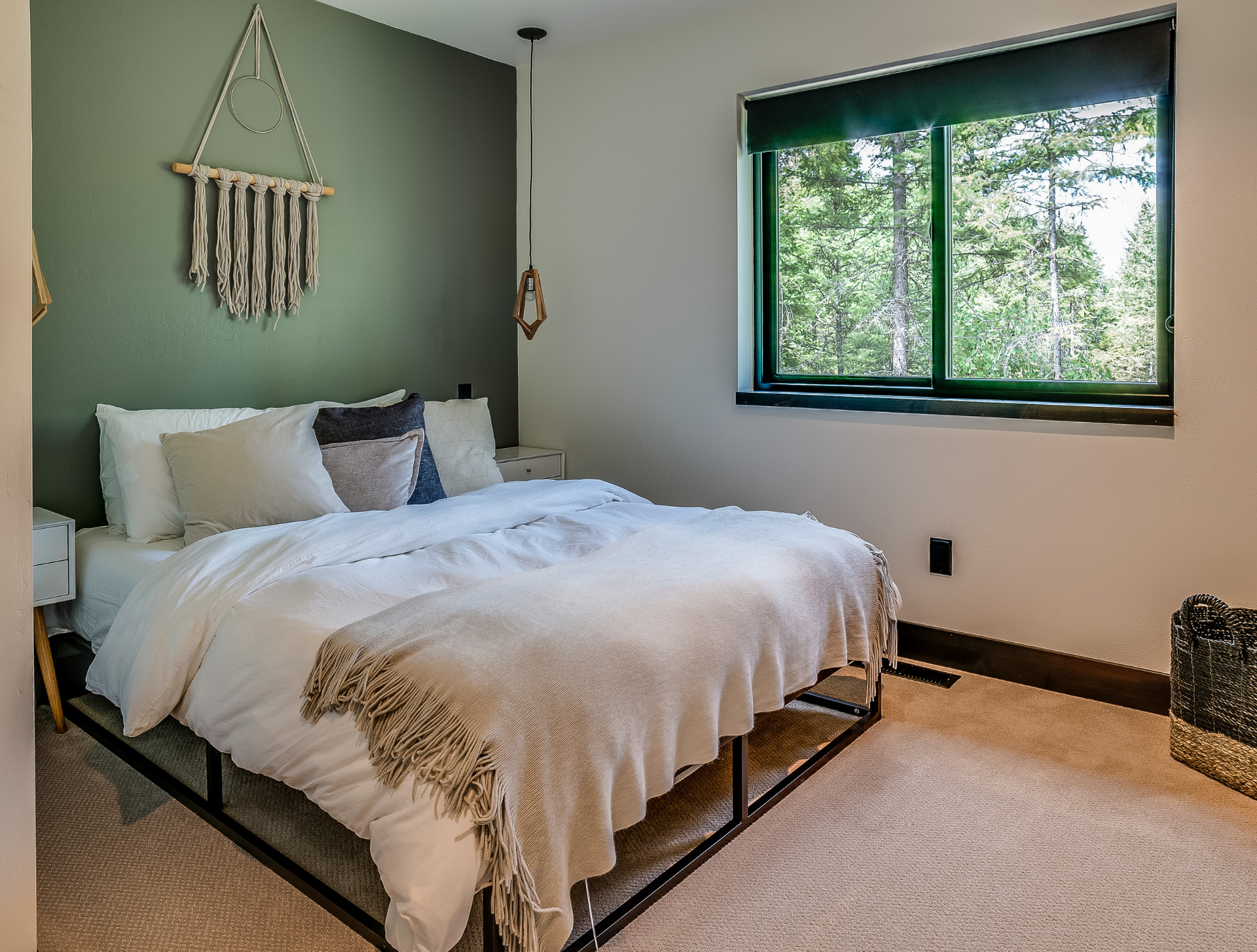 A bedroom with a large bed and a window.