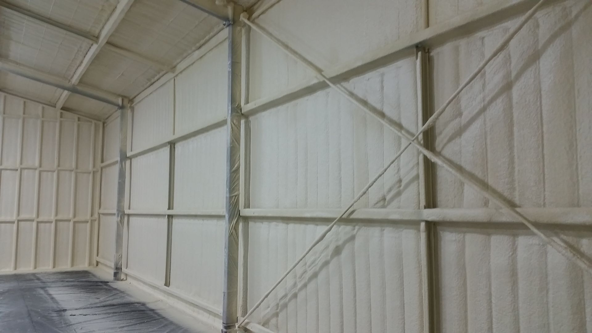 A Man in the Top of Scaffolding Spraying Insulation on the Ceiling | Pakenham, Vic | Advanced Foam & Coatings Pty Ltd