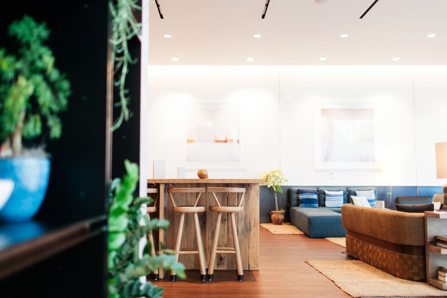 Un salon avec un canapé, une table et des tabourets.