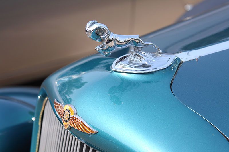A close up of a car with a hood ornament on it.