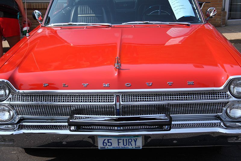 A red Plymouth with a license plate that says 65 Fury.