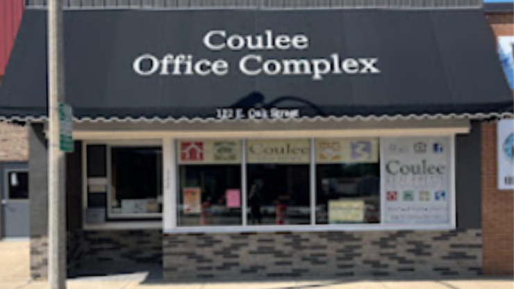 Storefront of Coulee Office Complex with a dark awning and glass windows.