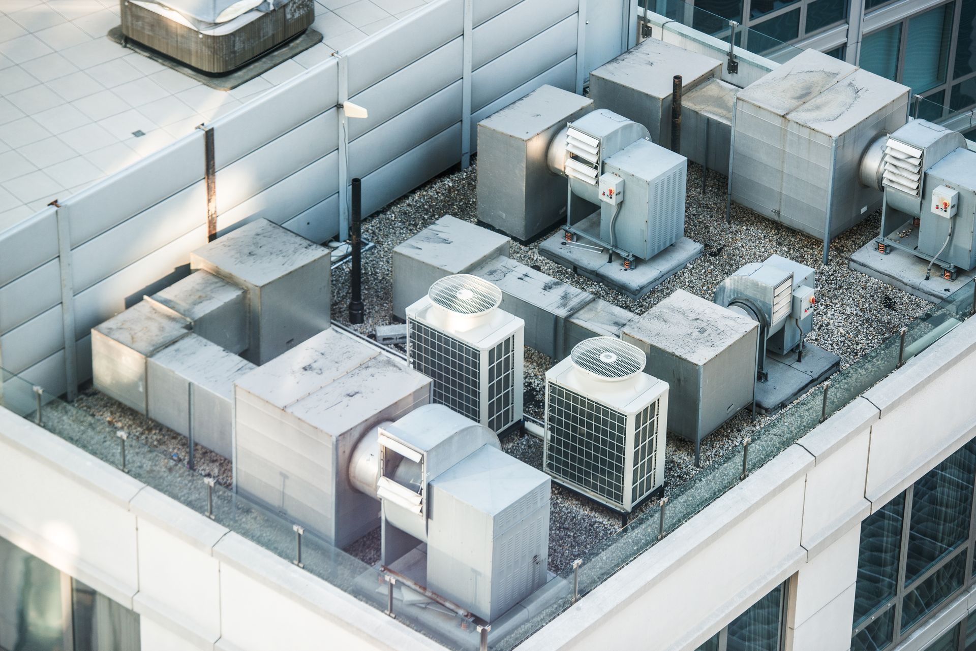 An aerial view of a building with a lot of air conditioning equipment on the roof.