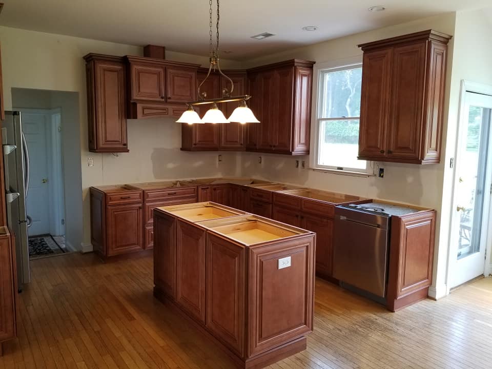 Crown Molding — Dark Wooden Cabinets with Classic Chandelier in Wilmington, De