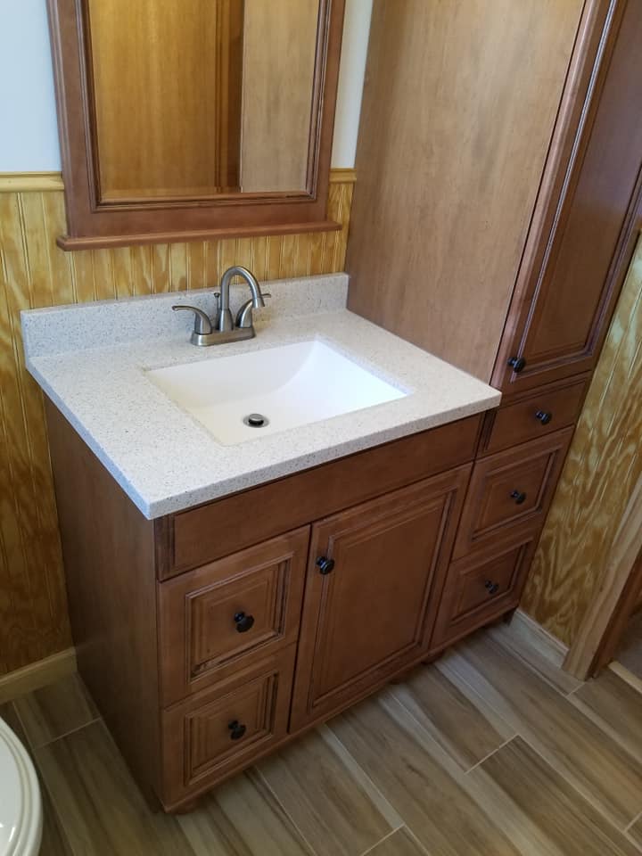 Cabinet Installation — Wooden Cabinet with White Granite Countertop in Bathroom in Wilmington, DE