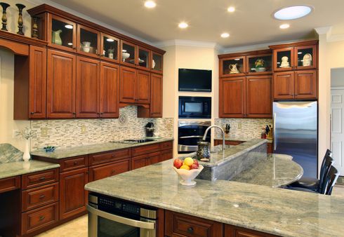Cabinets — Kitchen with Wood Cabinets and Marble Tops in Wilmington, DE