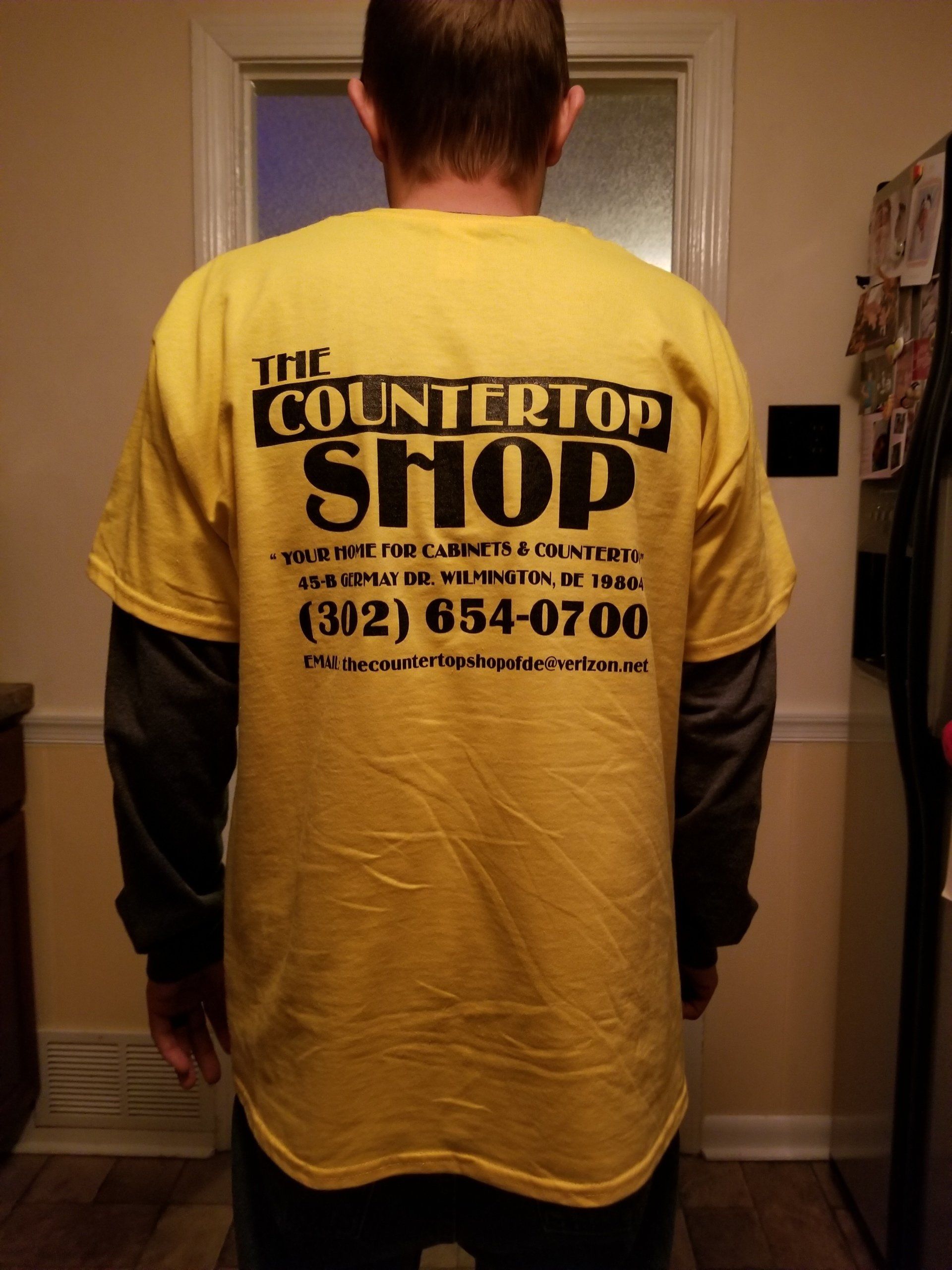 Crown Molding — A Man Wearing a Yellow T-shirt with The Countertop Shop Information at the Back in Wilmington, DE