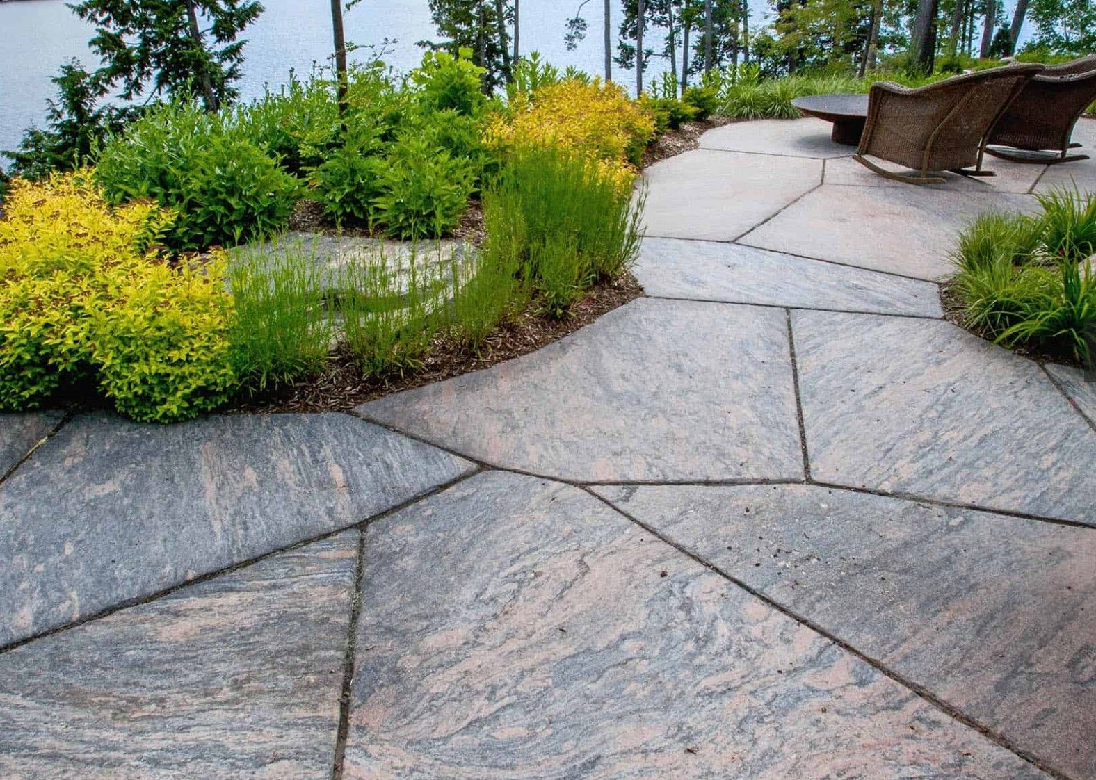 A patio with a rocking chair in the middle of it