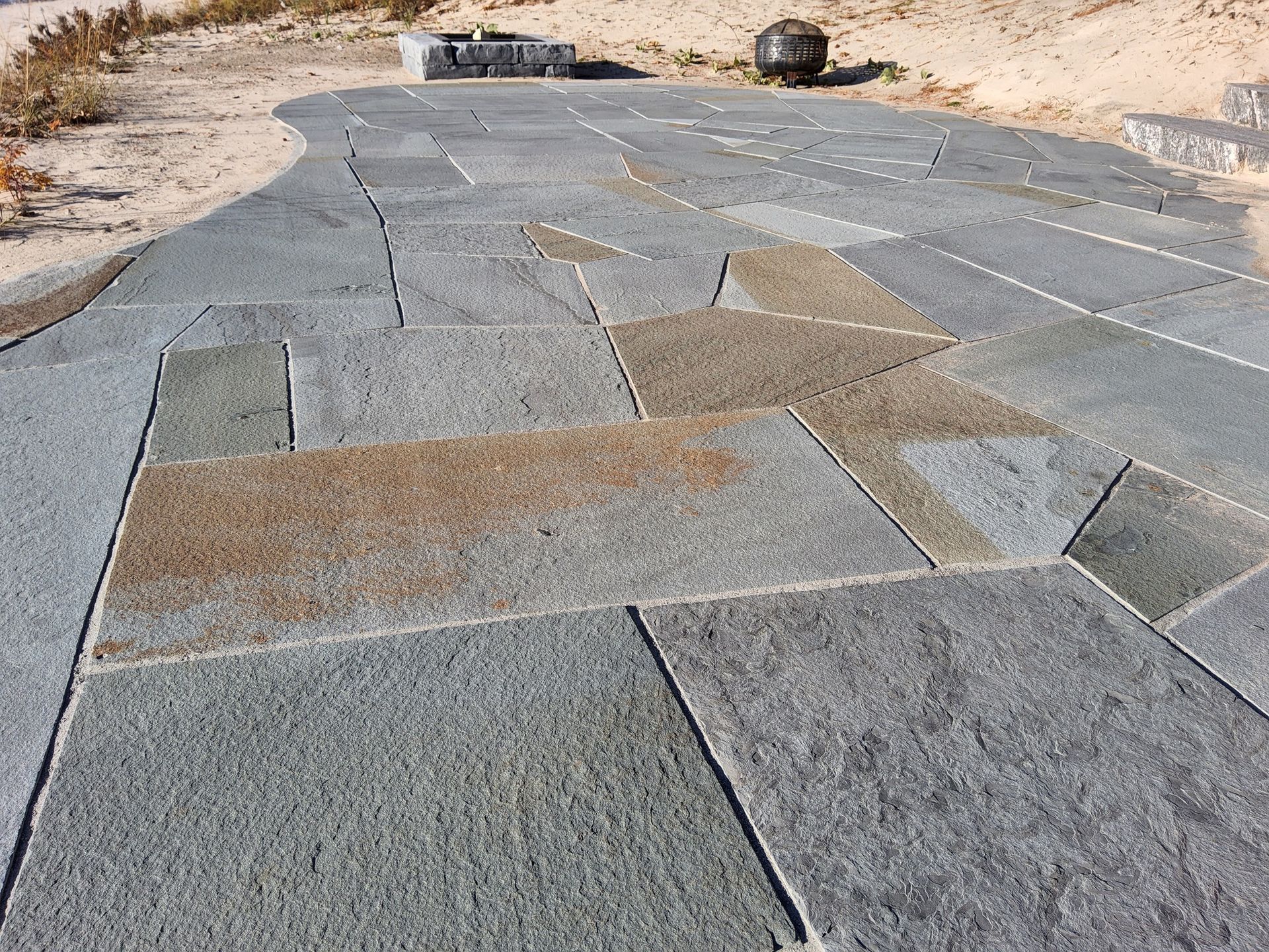 A stone walkway with a curve in the middle of it.