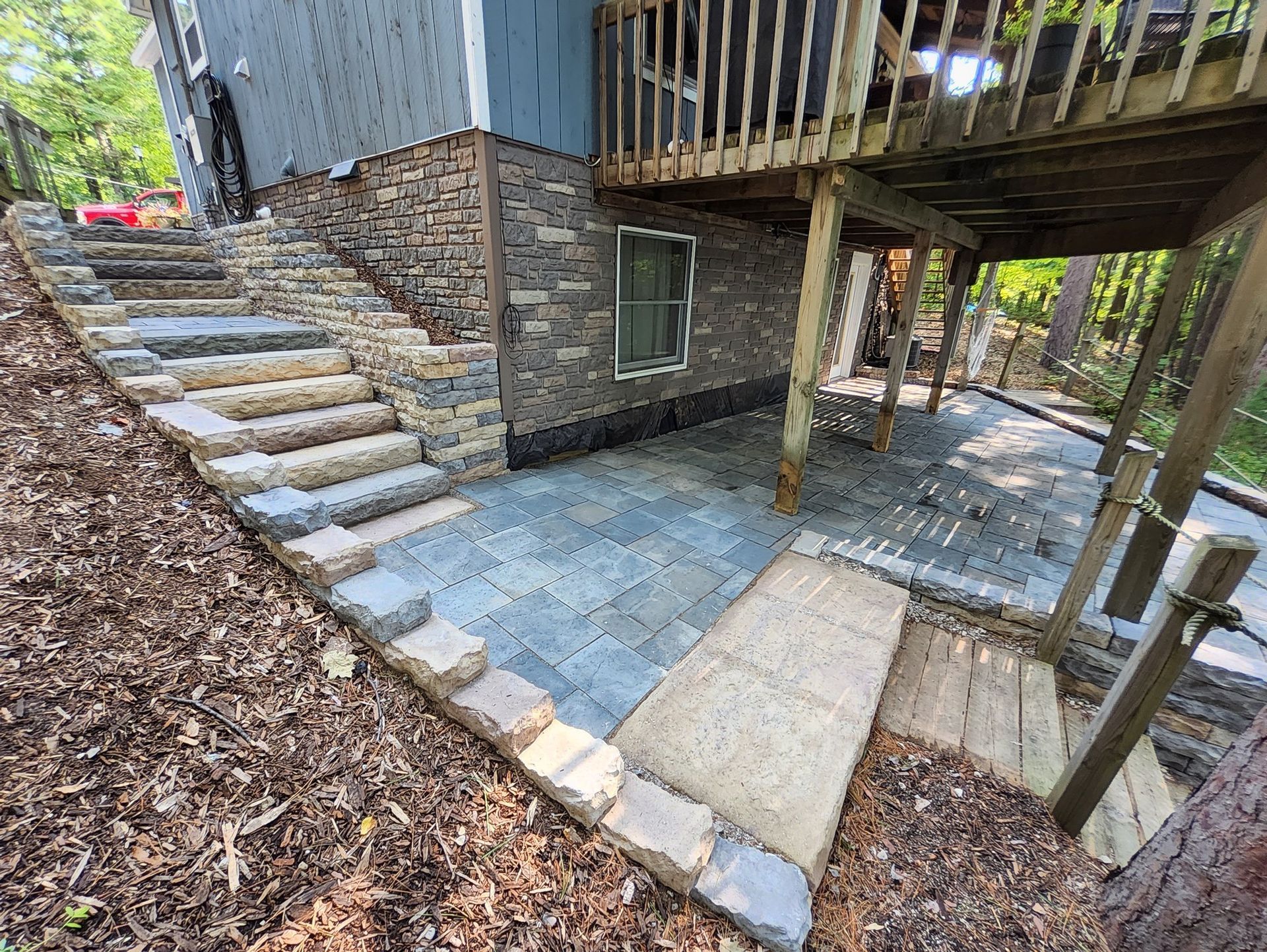 A house with a deck and stairs leading up to it.