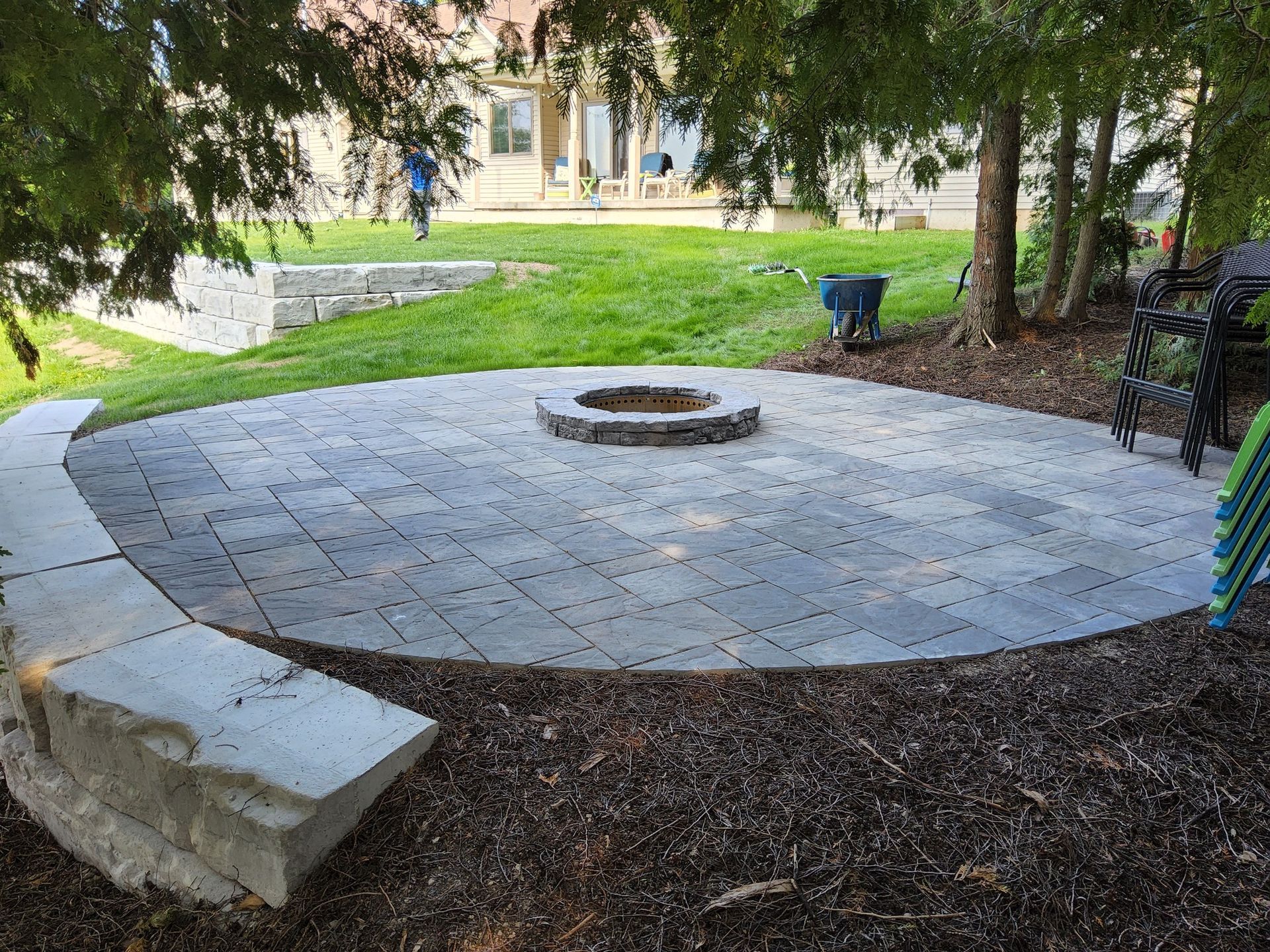 There is a fire pit in the middle of the patio.