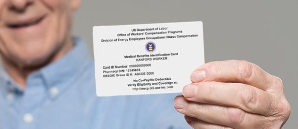 A man is holding a white card in his hand.